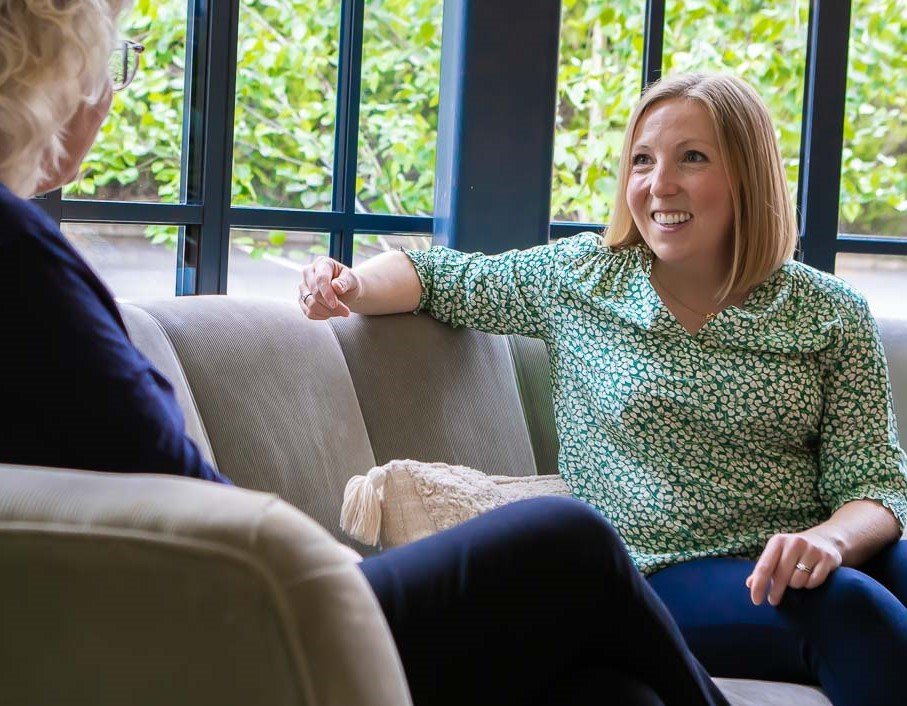 Angharad smiling and talking to a coaching client