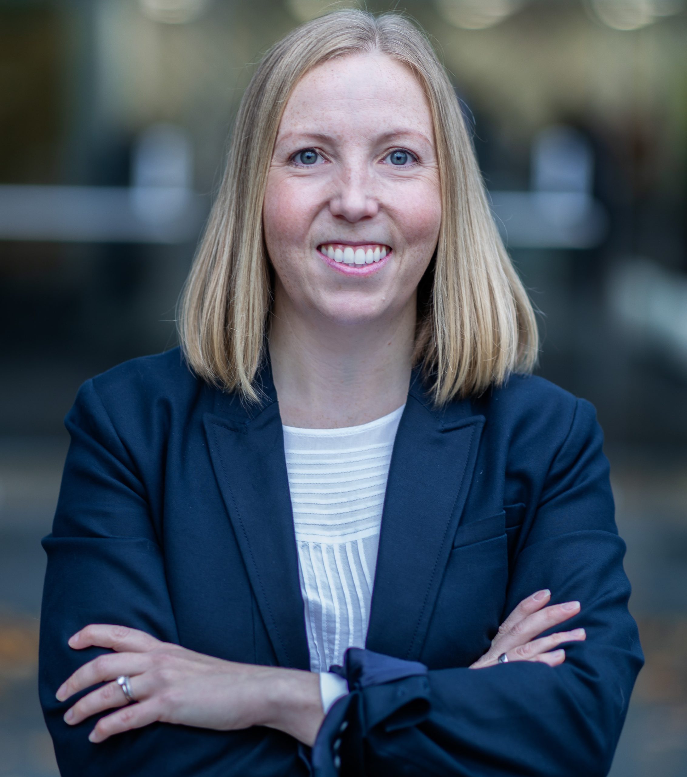 Angharad standing confidently with arms crossed