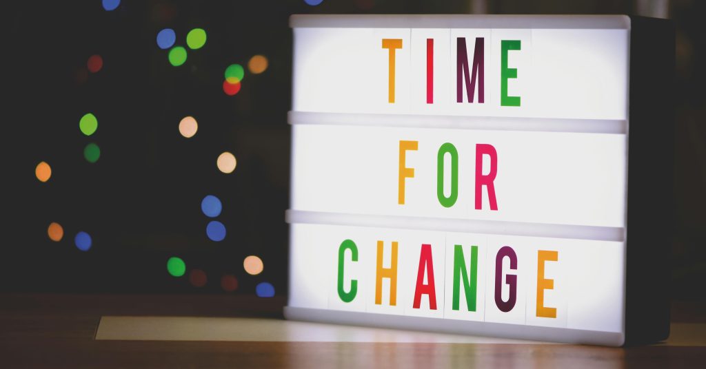 Colourful sign saying "Time for change".