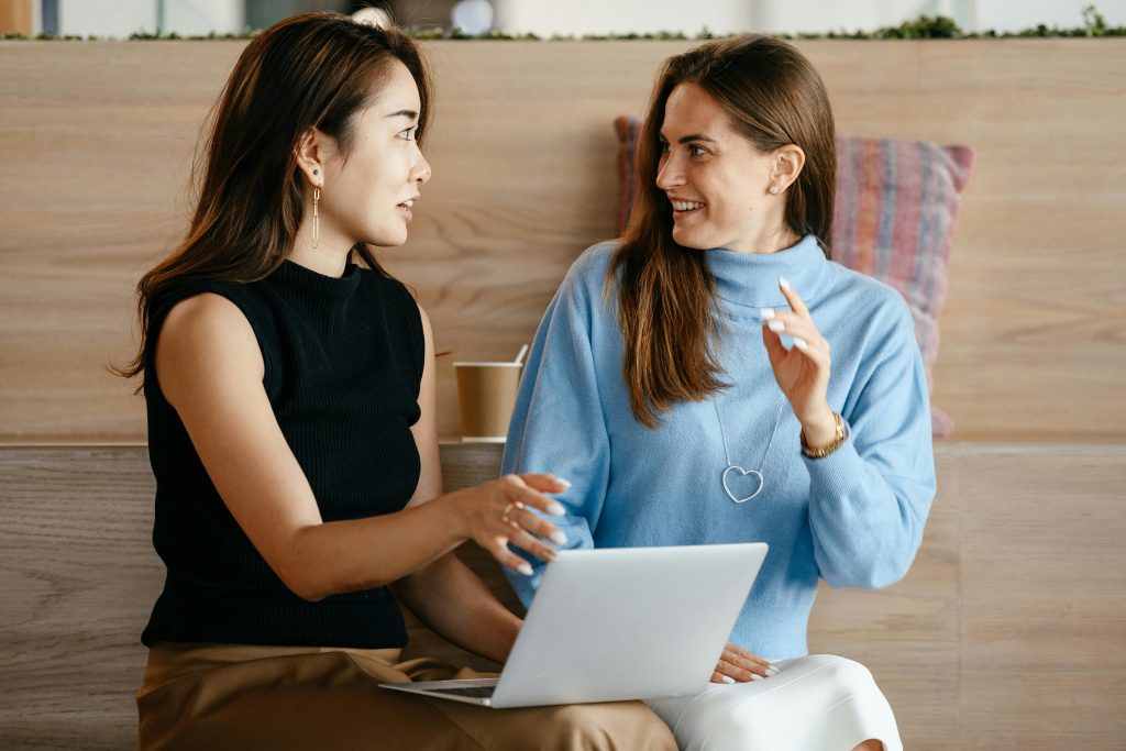 Two professional women talking animatedly